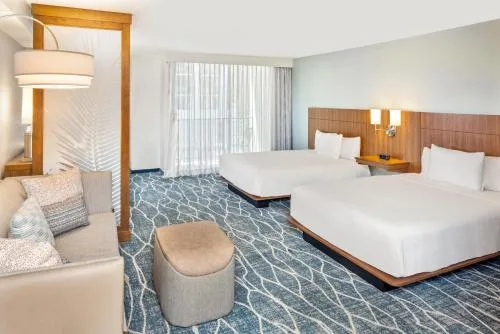 Accessible city view room with two beds and patterned carpet at Hyatt Place Waikiki Beach.