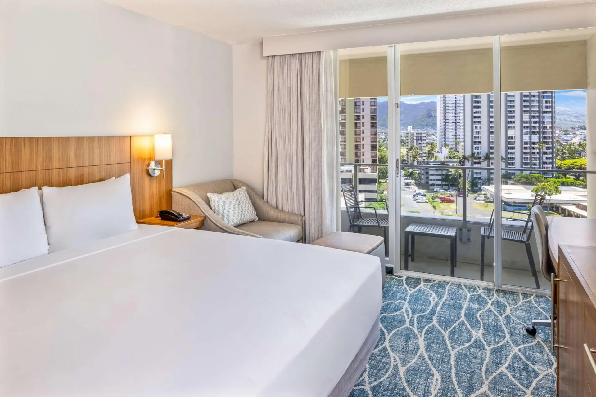 City View at Hyatt Place Waikiki Beach with king bed, balcony, and urban Honolulu views.