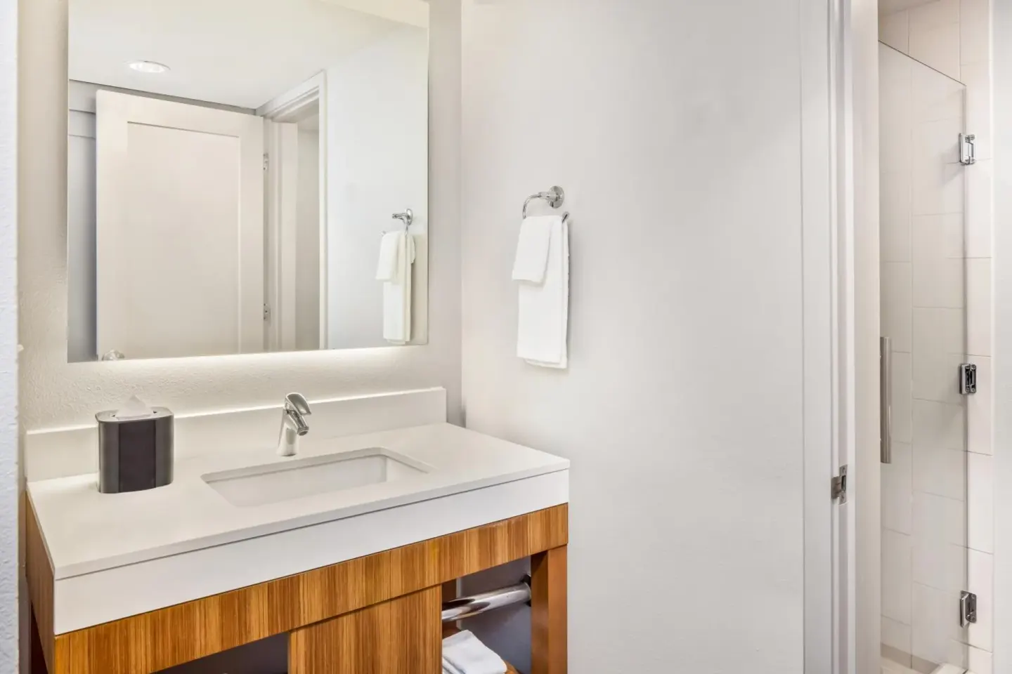 City View guest room bathroom vanity and shower door at Hyatt Place Waikiki Beach.