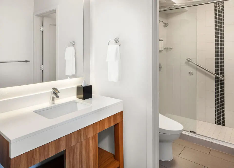 City View room bathroom vanity and glass shower at Hyatt Place Waikiki Beach.