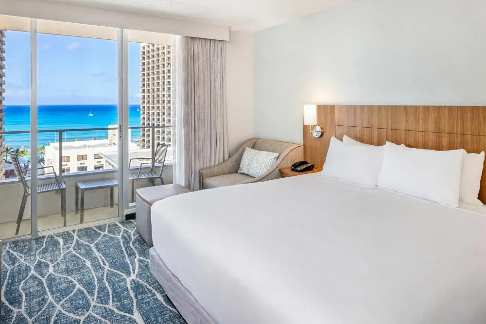 Ocean view king bed and sofa bed room with balcony at Hyatt Place Waikiki Beach.