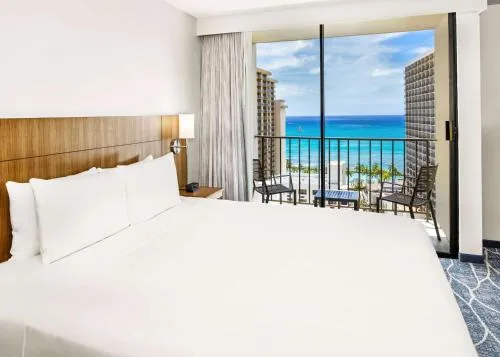 Ocean view king bed room with sliding balcony doors at Hyatt Place Waikiki Beach.