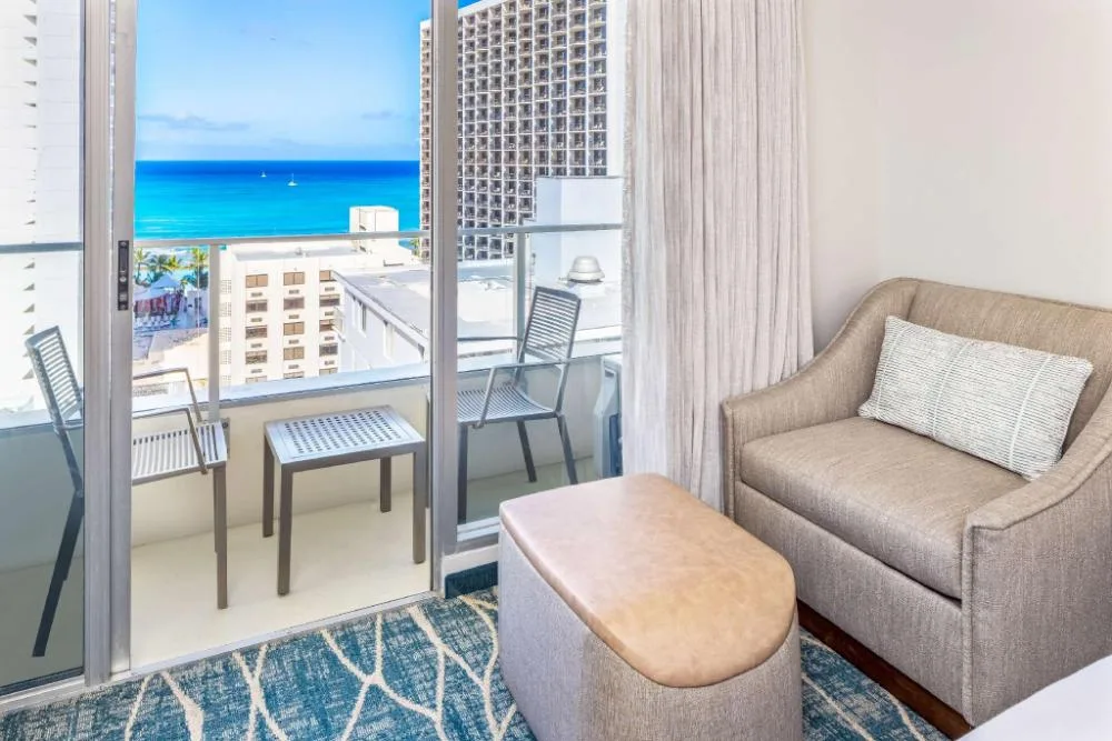 Ocean view room balcony seating and sofa bed area at Hyatt Place Waikiki Beach.