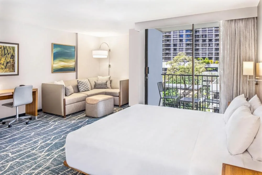 Specialty City View room with bed, sofa bed and balcony at Hyatt Place Waikiki Beach.