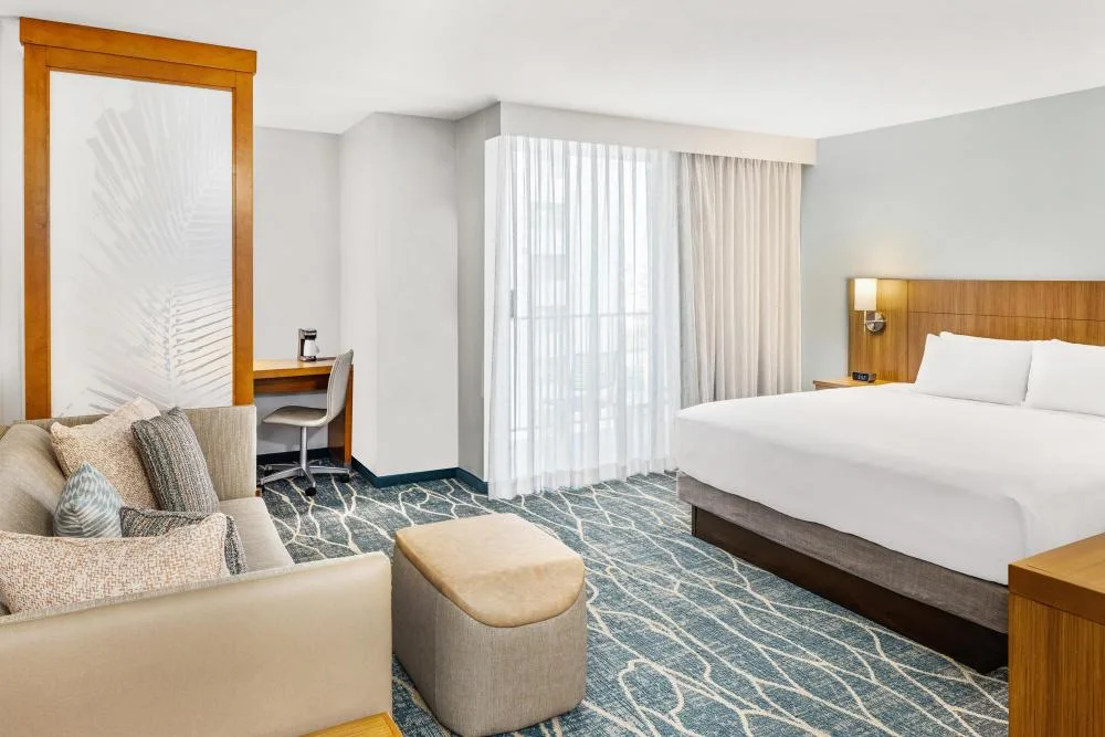 Specialty City View room with sofa bed, ottoman and bed at Hyatt Place Waikiki Beach.