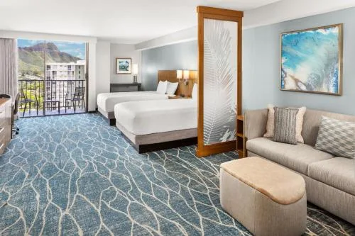 Two-bed Specialty Mountain View room with sofa and balcony at Hyatt Place Waikiki Beach.