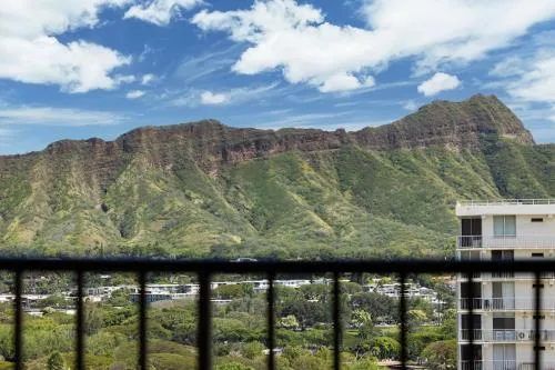 Green mountain ridges seen past a balcony railing at Hyatt Place Waikiki Beach.