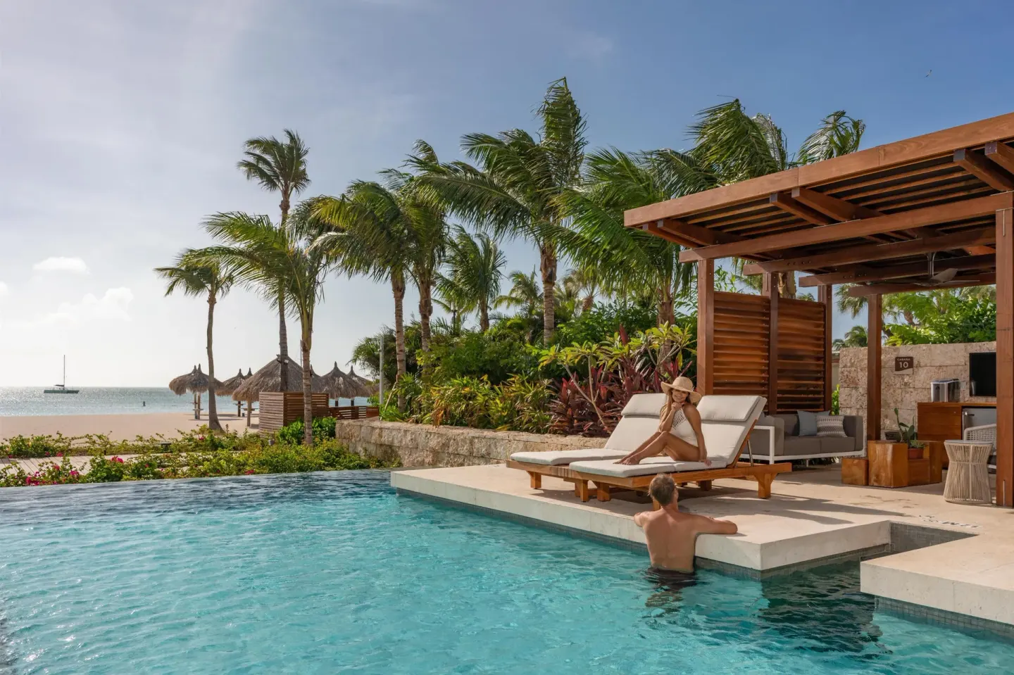 Poolside cabana with lounge chairs facing the beach at Hyatt Regency Aruba Resort and Casino.