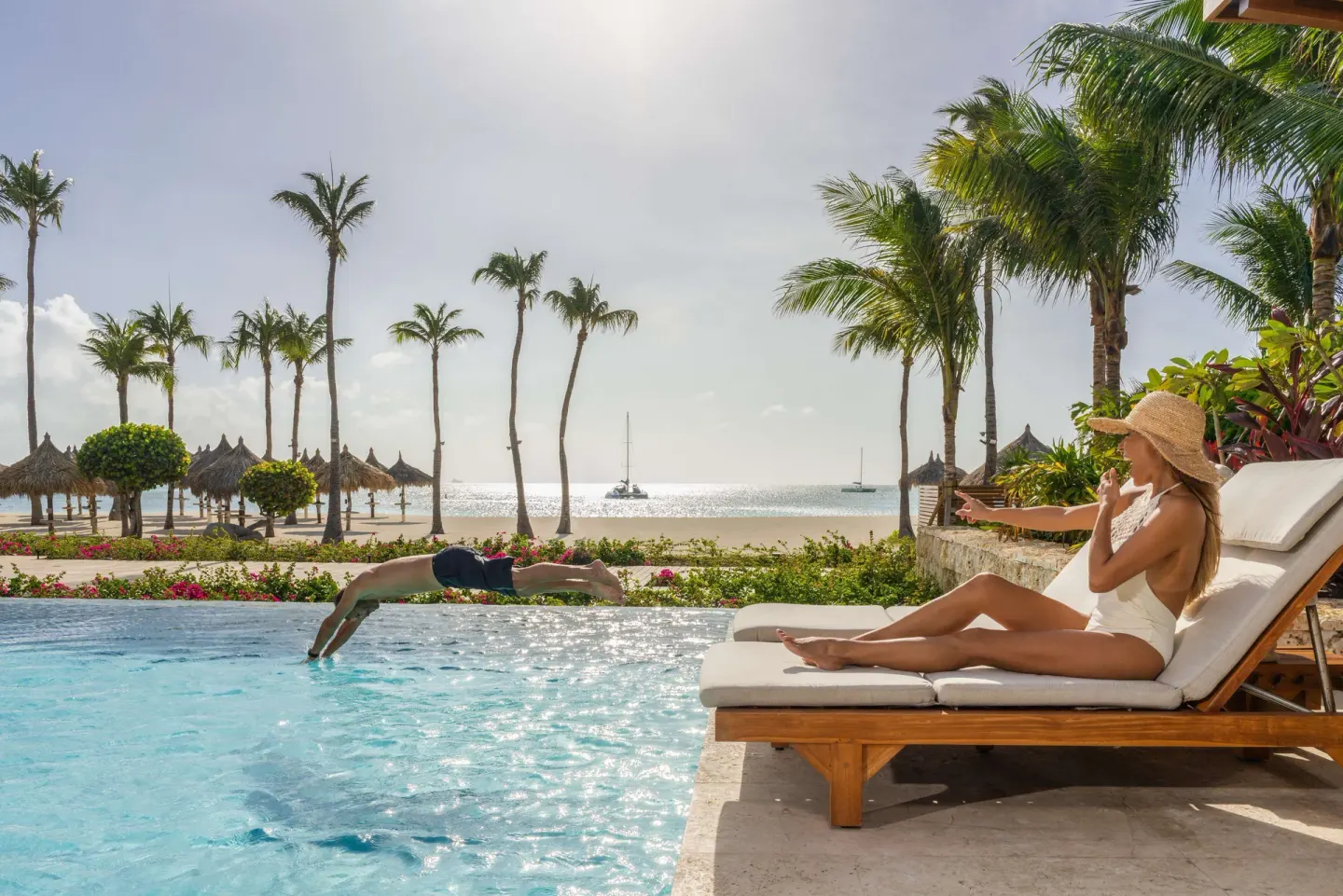 Poolside loungers beside the beach at Hyatt Regency Aruba Resort and Casino.