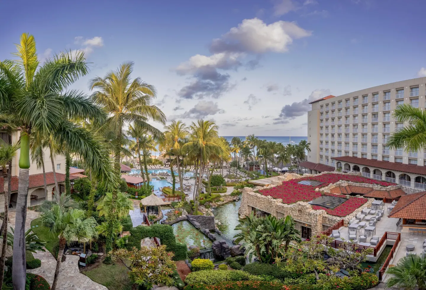 Palm-filled resort grounds and pools at Hyatt Regency Aruba Resort and Casino.