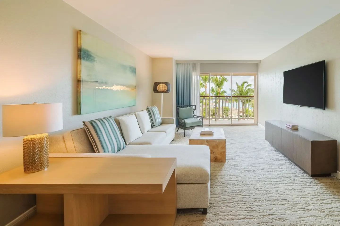 Suite living area with sofa and balcony view at Hyatt Regency Aruba Resort and Casino.