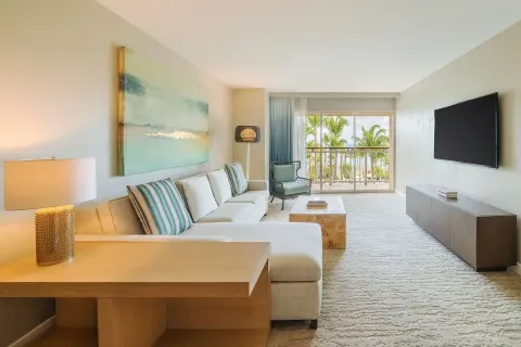 Suite living area with sofa and balcony view at Hyatt Regency Aruba Resort and Casino.