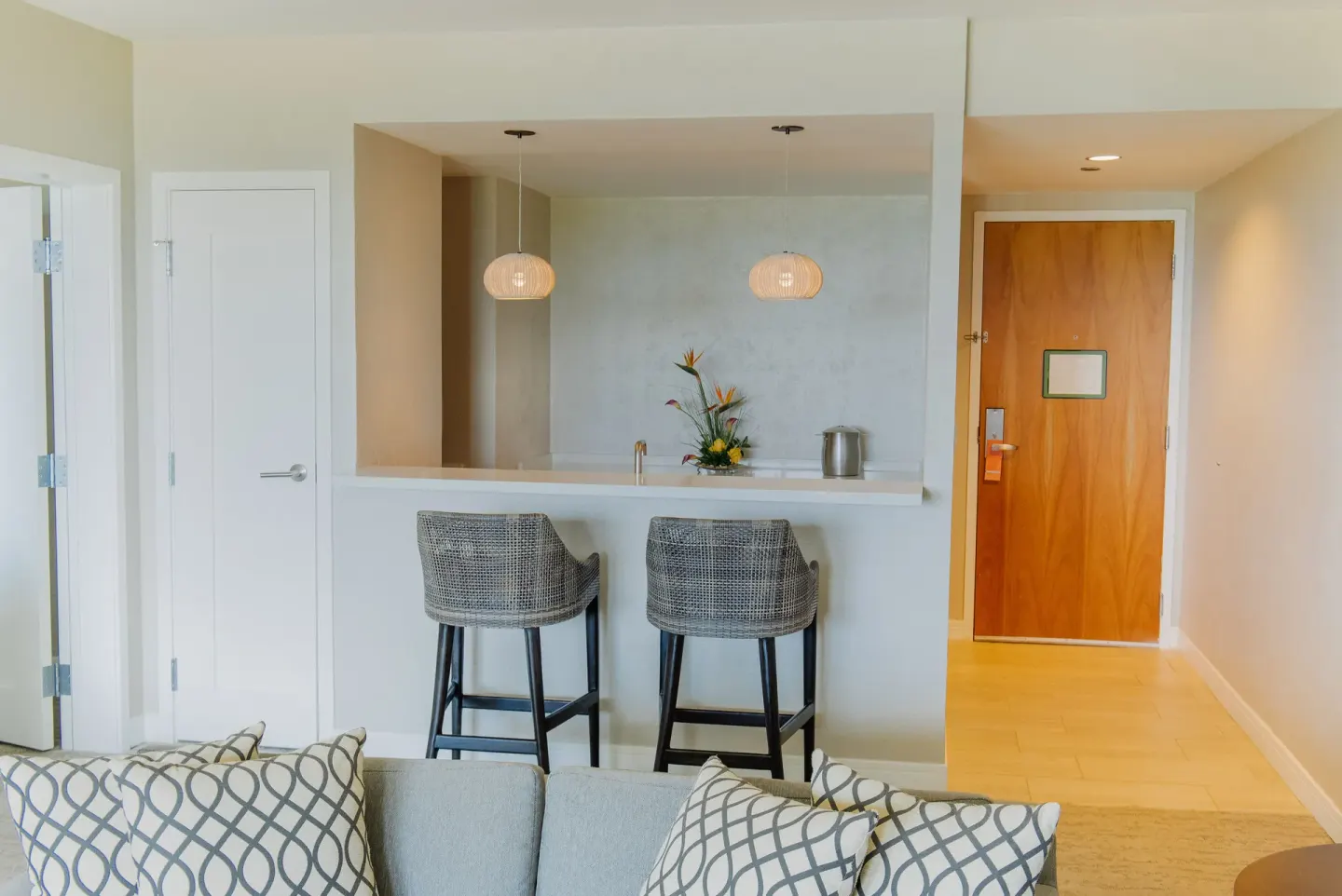 Suite wet bar with stools and entry door at Hyatt Regency Aruba Resort and Casino.