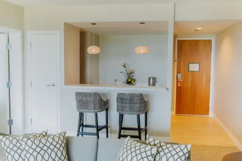 Suite wet bar with stools and entry door at Hyatt Regency Aruba Resort and Casino.