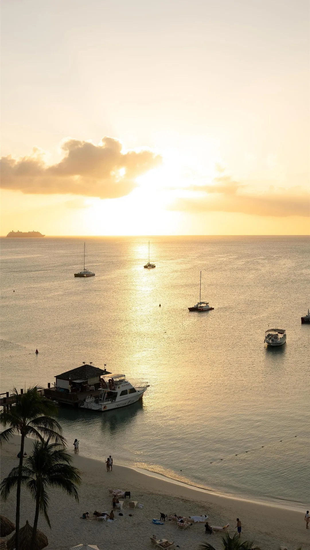 Sunset over the beach and anchored boats at Hyatt Regency Aruba Resort and Casino.