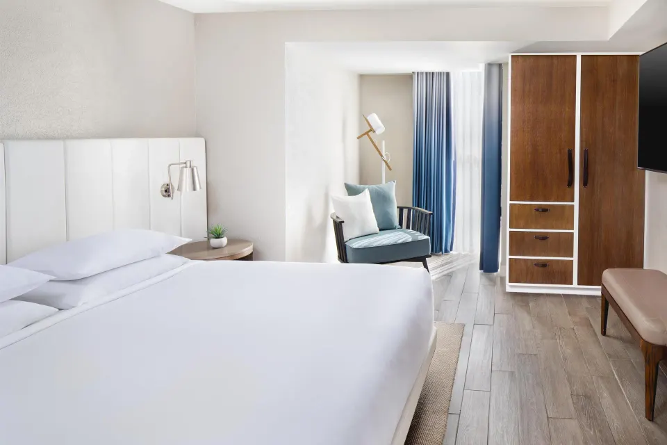 Family Suite bedroom with king bed and seating at Hyatt Regency Aruba Resort and Casino.