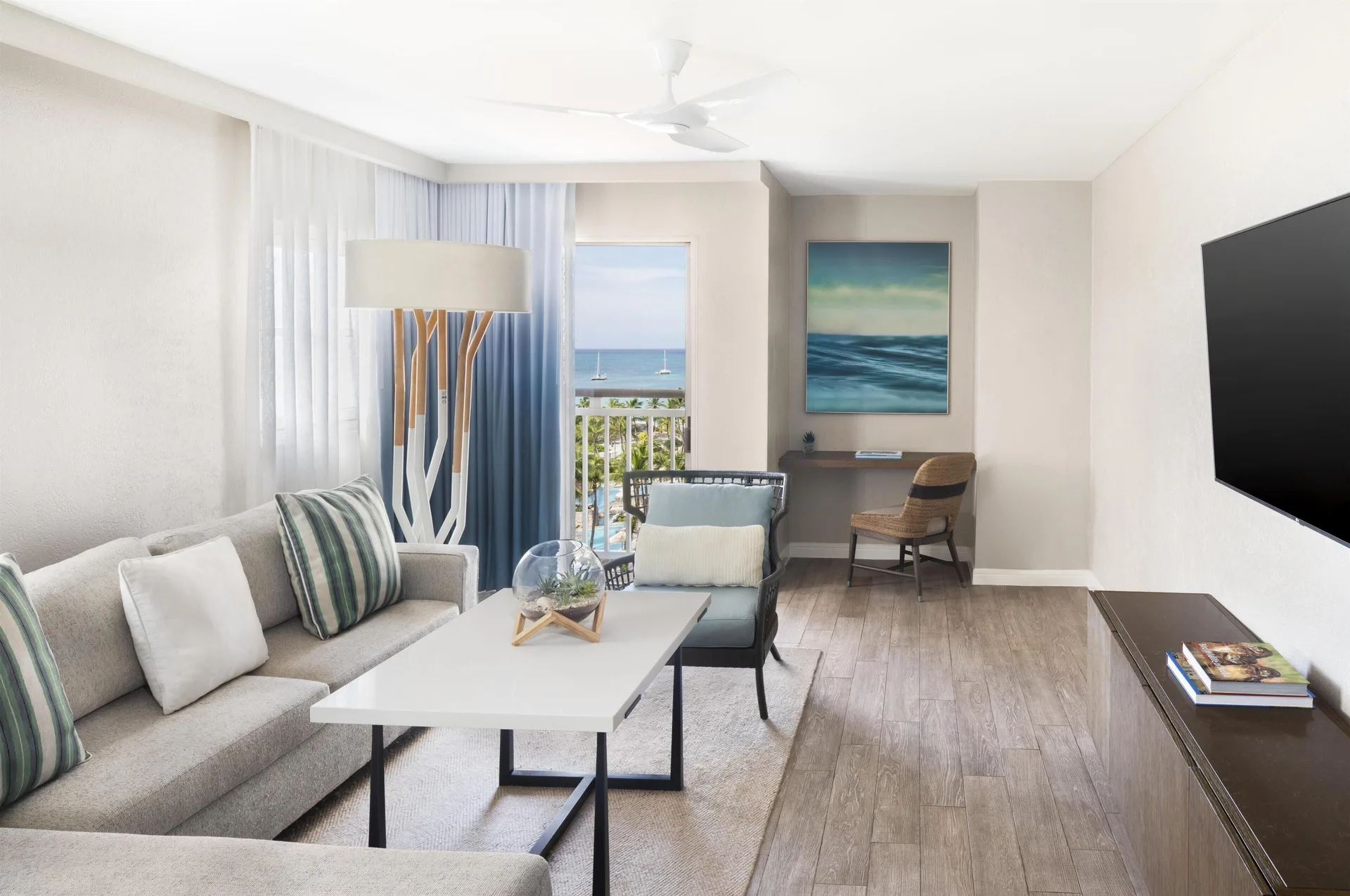 Family Suite living area with sofa and ocean view at Hyatt Regency Aruba Resort and Casino.