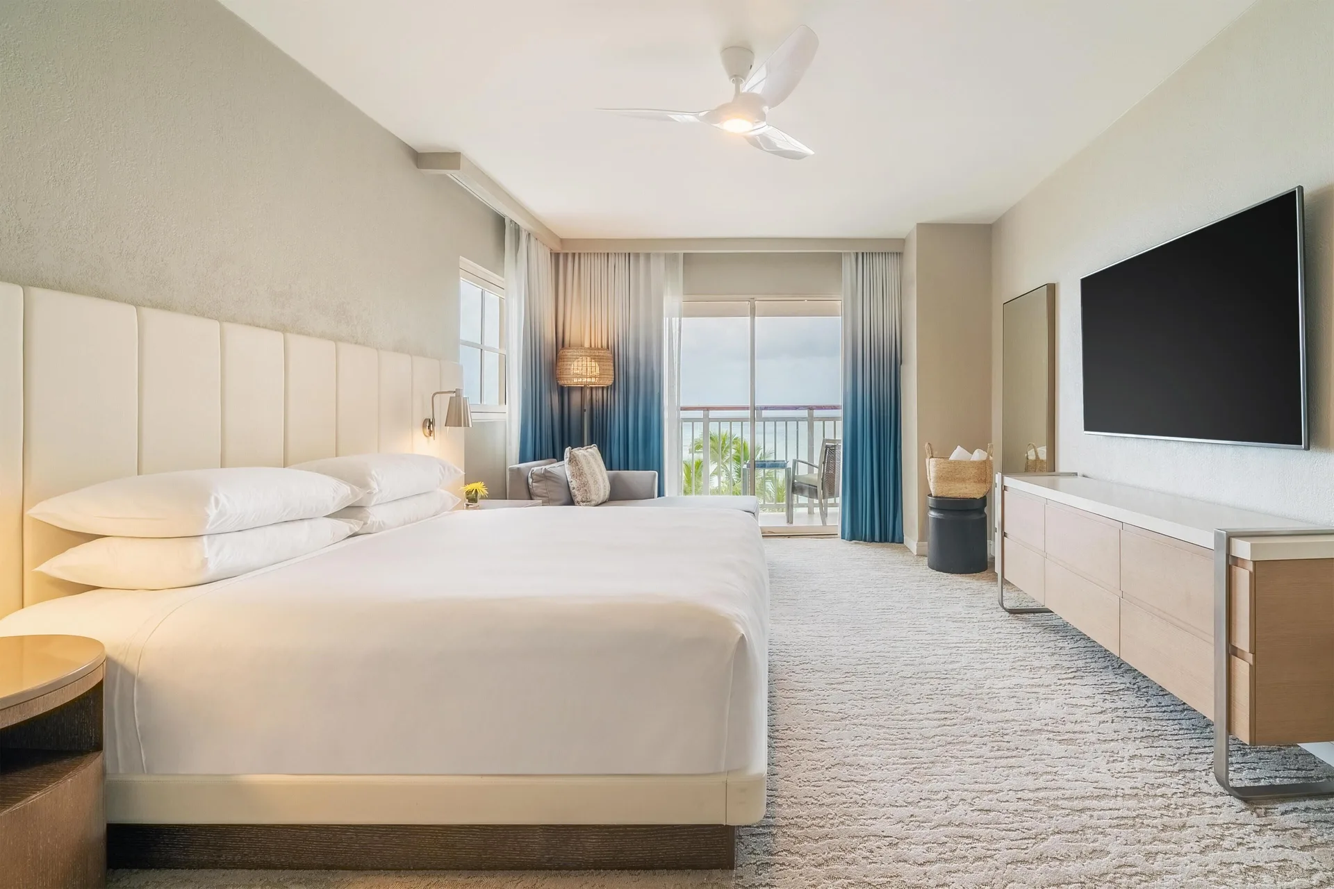 King bed guest room with balcony at Hyatt Regency Aruba Resort and Casino.