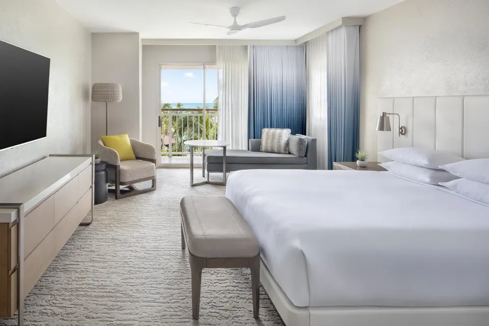 King resort-view room with sofa and balcony at Hyatt Regency Aruba Resort and Casino.