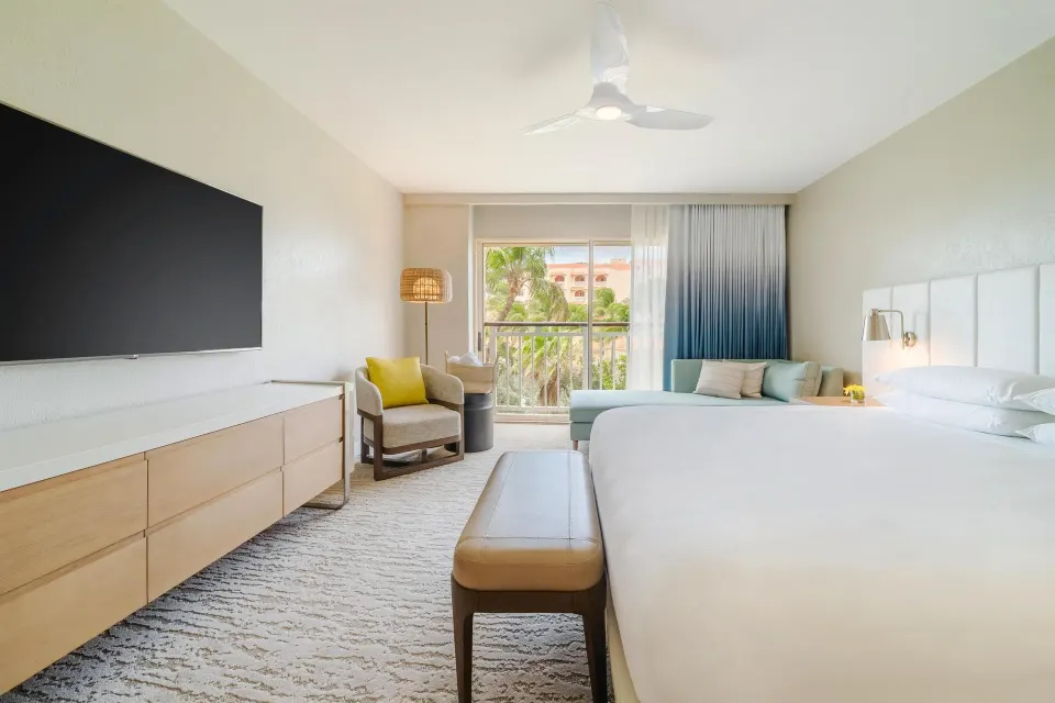 King resort view room with dresser and chaise at Hyatt Regency Aruba Resort and Casino.