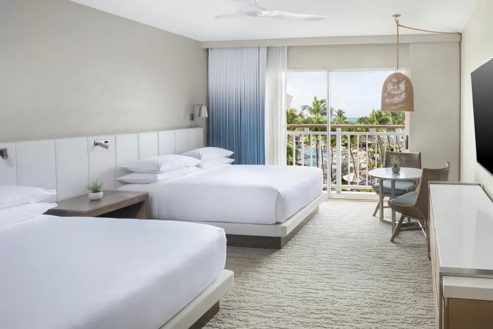 Two-bed room with balcony and palm view at Hyatt Regency Aruba Resort and Casino.