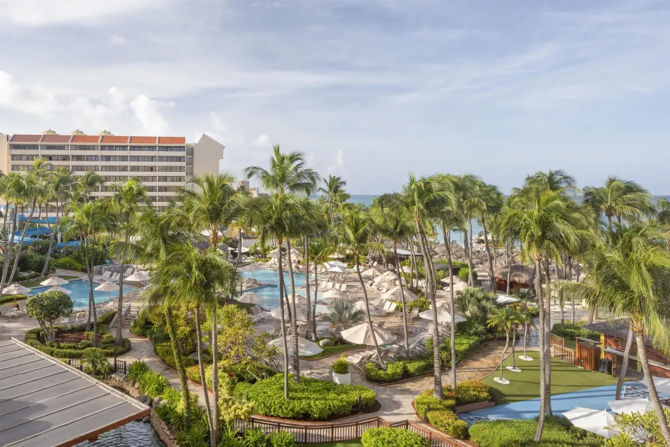 Resort view over palms, pools, pathways, and ocean at Hyatt Regency Aruba Resort and Casino.