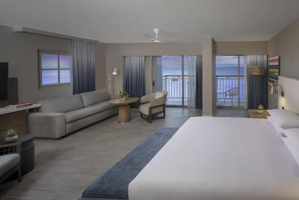 King studio with sofa and oceanfront balconies at Hyatt Regency Aruba Resort and Casino.
