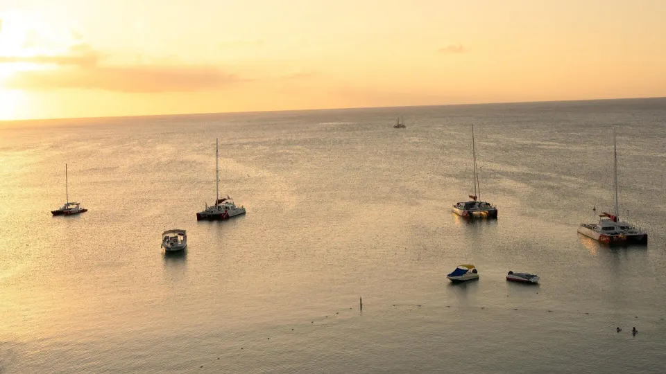 Sunset ocean view with anchored boats at Hyatt Regency Aruba Resort and Casino.