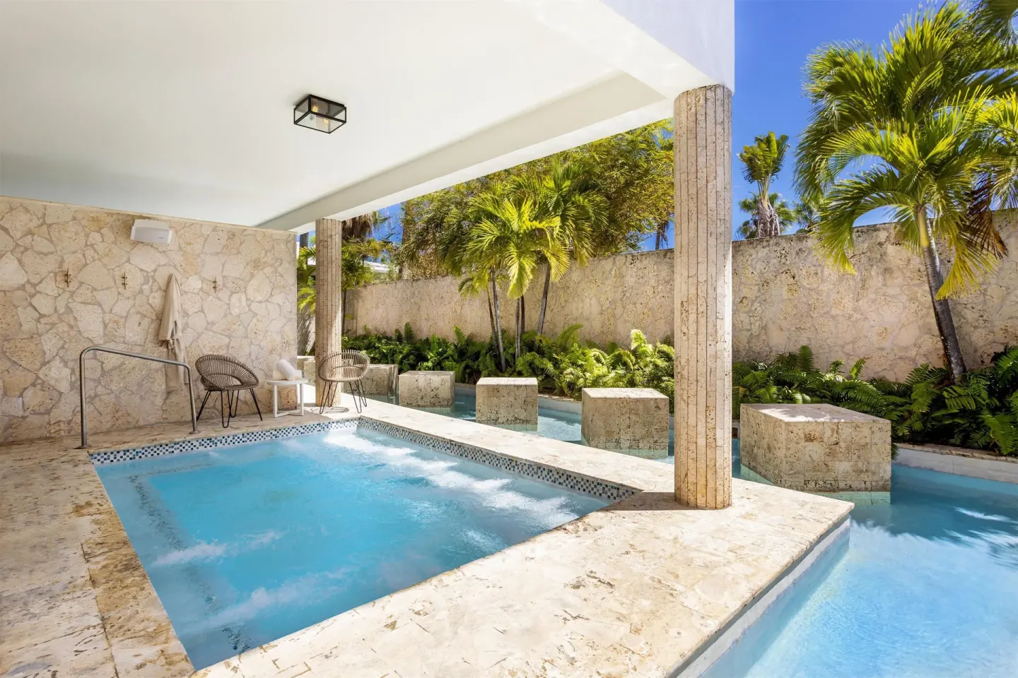 A stone-lined outdoor spa pool and plunge area at Hyatt Regency Grand Reserve Puerto Rico.