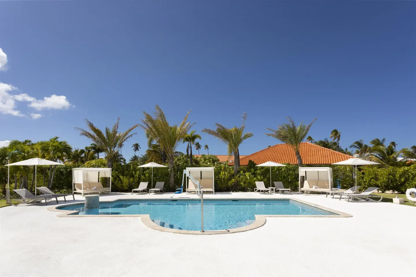 A quiet pool deck with cabanas and lounge chairs at Hyatt Regency Grand Reserve Puerto Rico.
