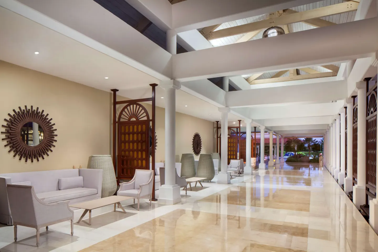 Covered resort corridor with seating and columns at Hyatt Regency Grand Reserve Puerto Rico.