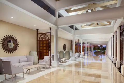 Covered resort corridor with seating and columns at Hyatt Regency Grand Reserve Puerto Rico.