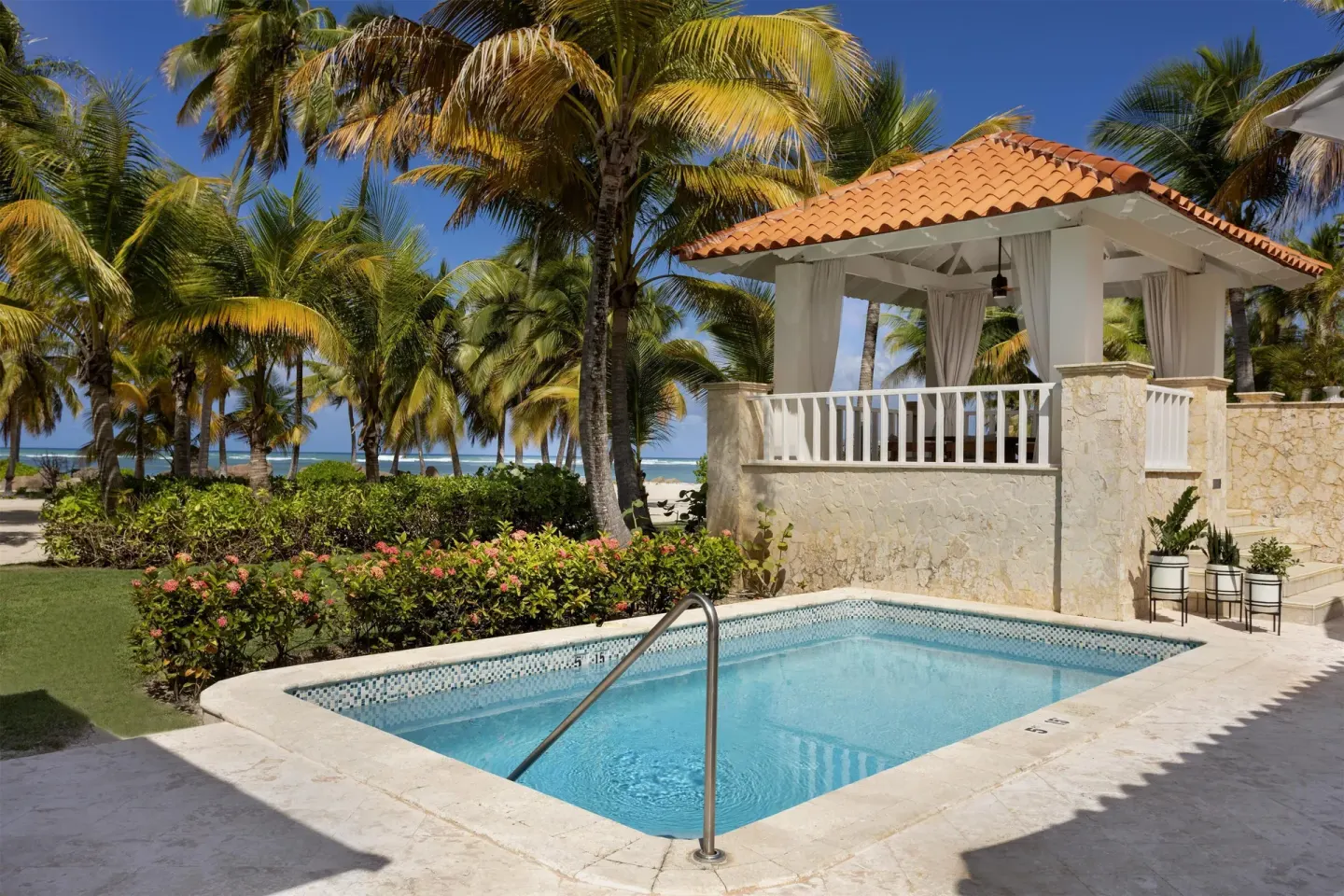 Small pool beside a tiled-roof cabana and palms at Hyatt Regency Grand Reserve Puerto Rico.