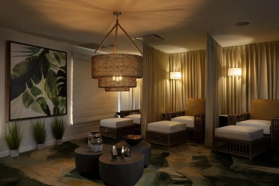 A softly lit lounge with wicker chairs and tropical artwork at Hyatt Regency Grand Reserve Puerto Rico.