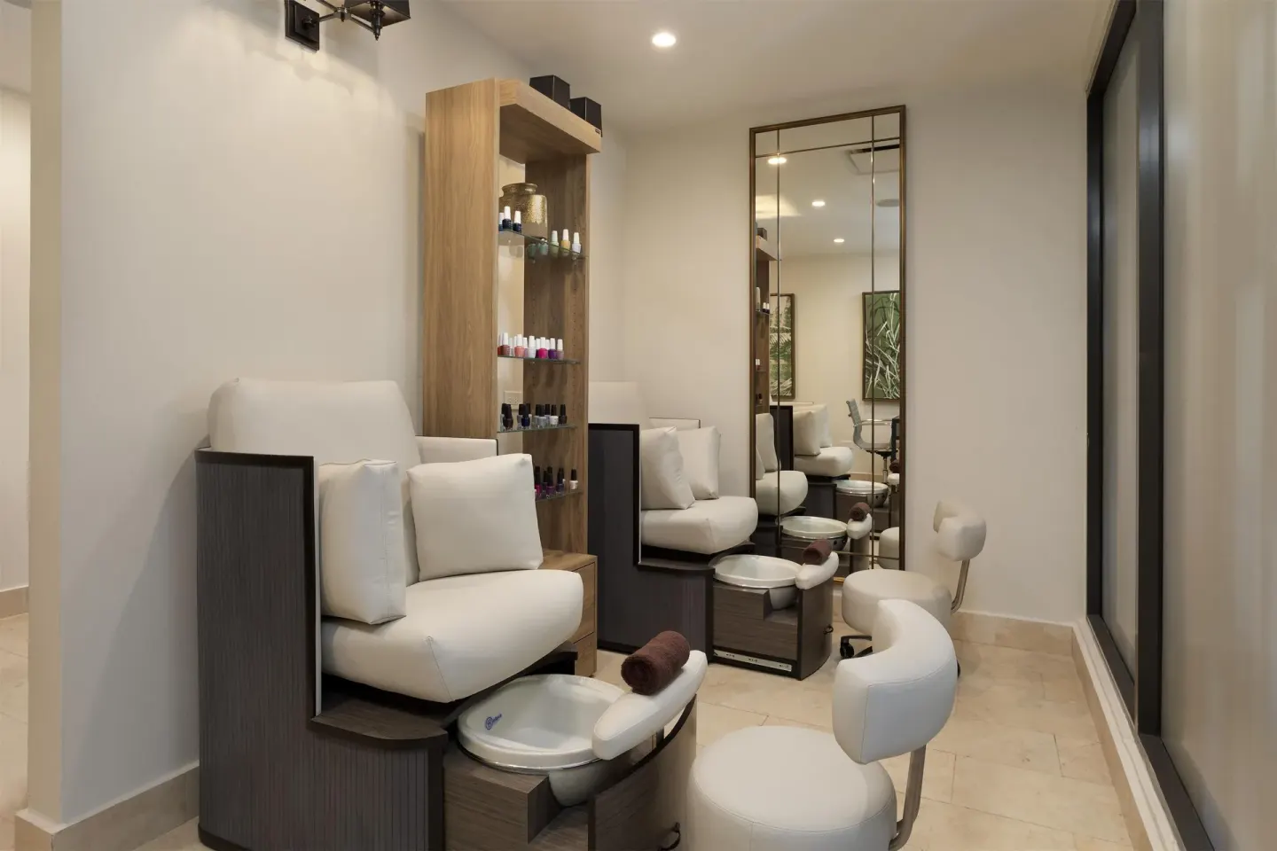 A spa pedicure station with white chairs and nail polish displays at Hyatt Regency Grand Reserve Puerto Rico.