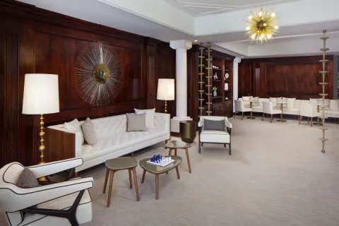 Lounge with white sofas, wood paneling and chess table at Hyatt Regency Grand Reserve Puerto Rico.
