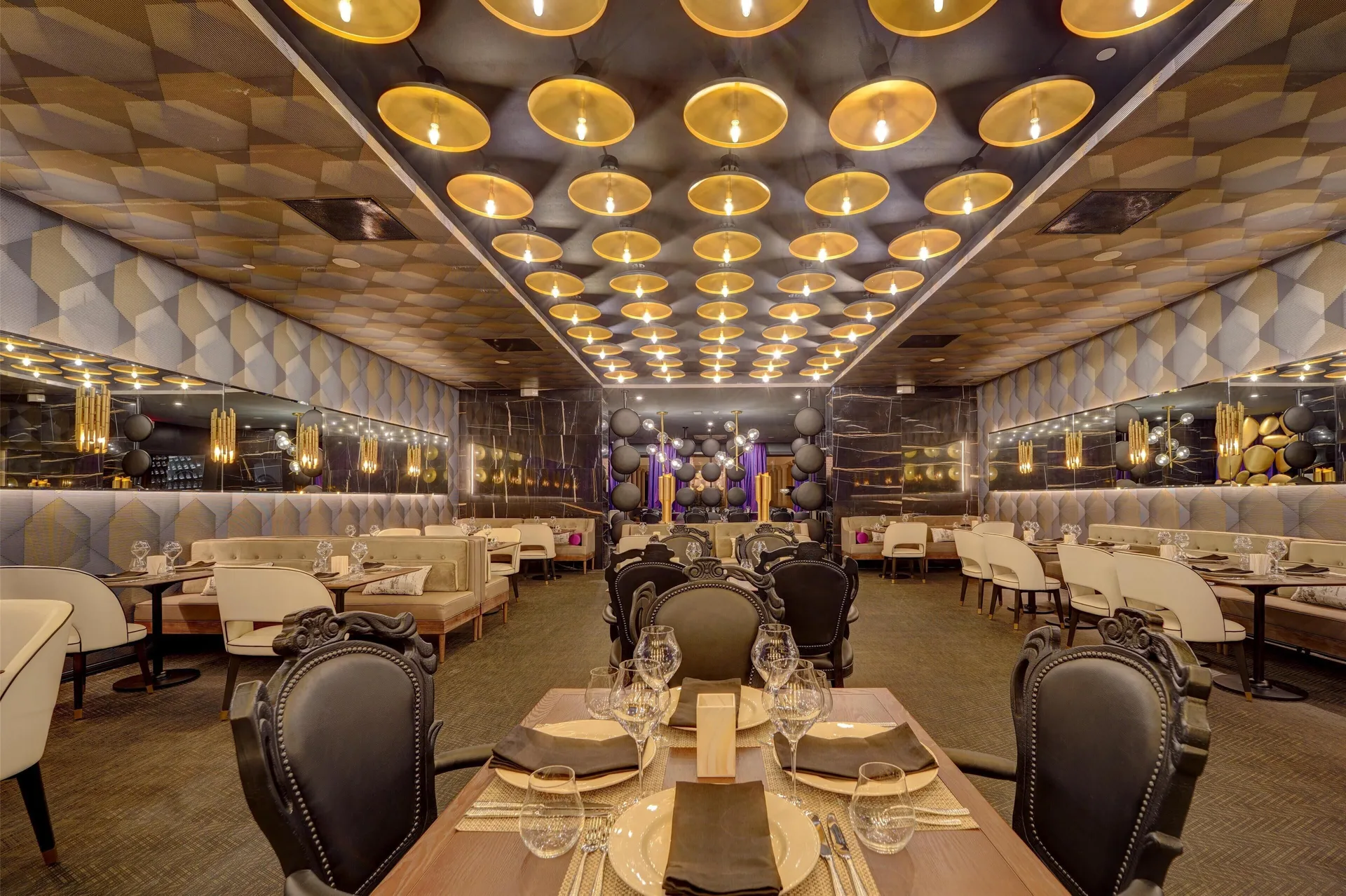 Elegant dining room with gold ceiling lights at Hyatt Regency Grand Reserve Puerto Rico.