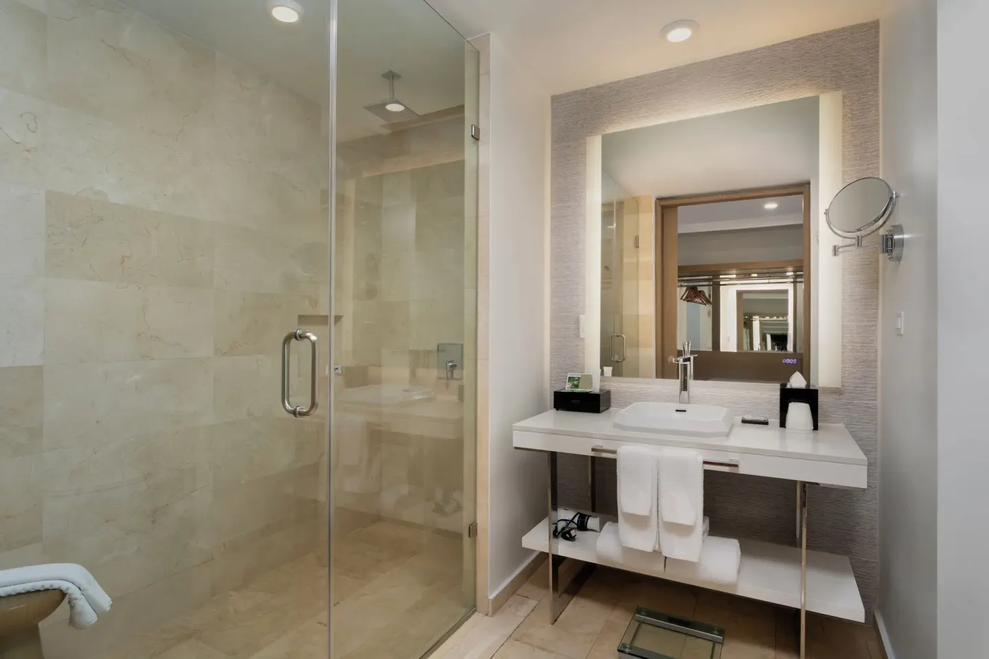Deluxe Garden View bathroom with lit mirror and glass shower at Hyatt Regency Grand Reserve Puerto Rico.