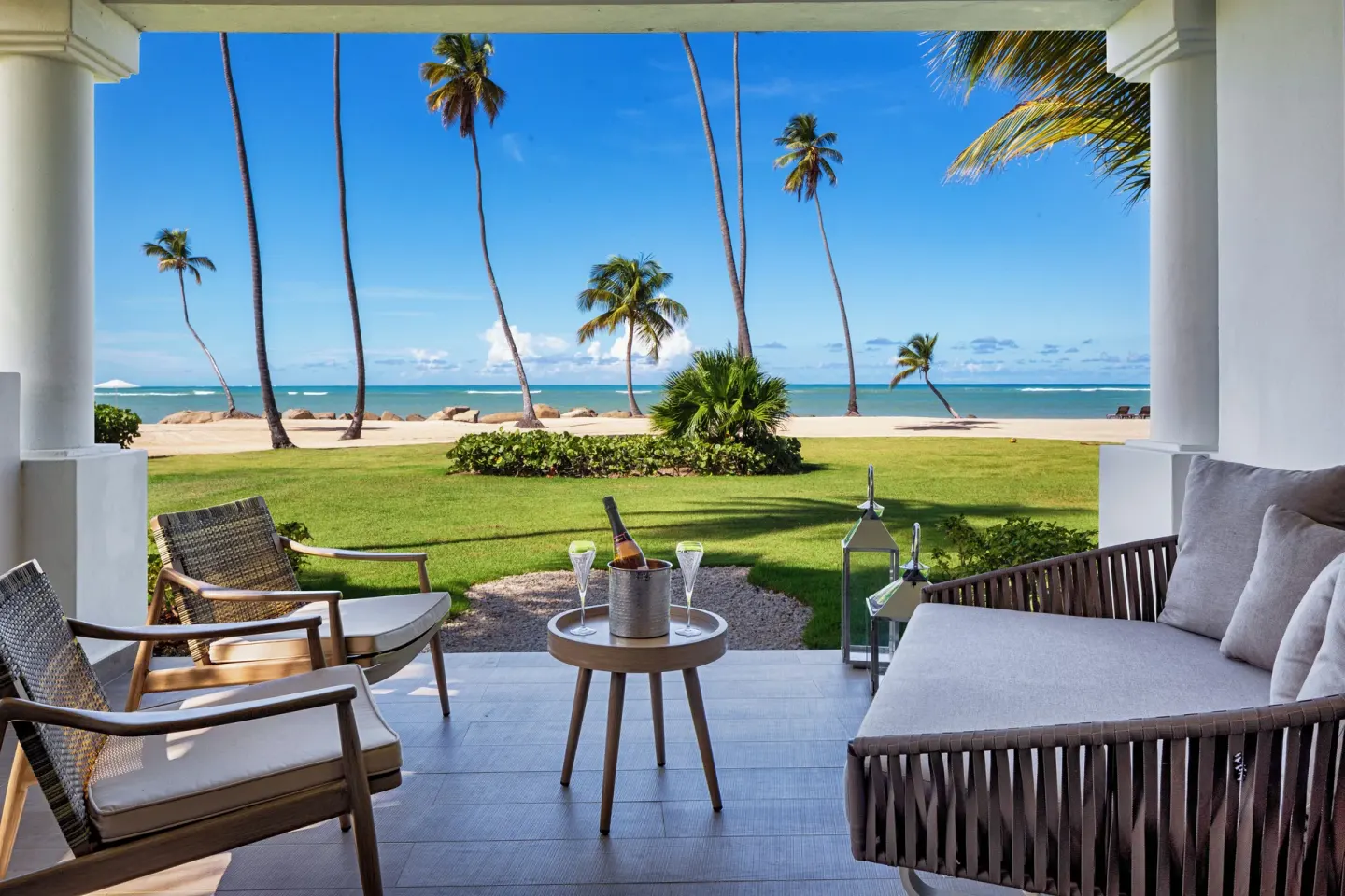 Oceanfront patio with sofa, chairs and sea view at Hyatt Regency Grand Reserve Puerto Rico.