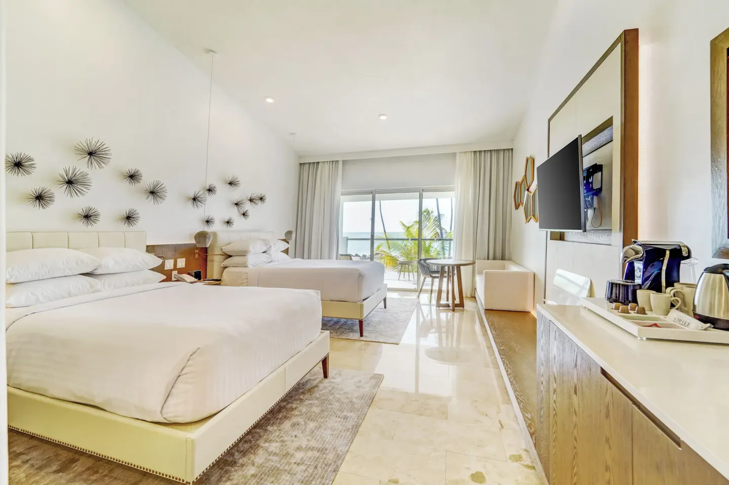 Oceanfront deluxe room with two beds and balcony view at Hyatt Regency Grand Reserve Puerto Rico.