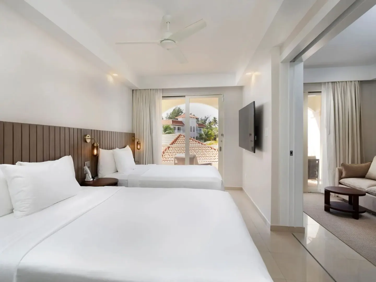 Deluxe Villa Ocean View Queen bedroom at Hyatt Regency Grand Reserve Puerto Rico with two beds and balcony doors.