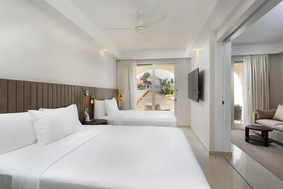 Deluxe Villa bedroom with two beds and sitting area at Hyatt Regency Grand Reserve Puerto Rico.