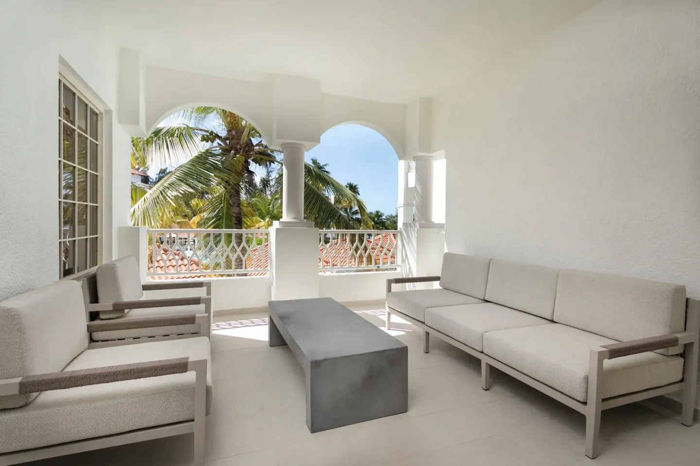 Premier Villa terrace with sofa seating and palm view at Hyatt Regency Grand Reserve Puerto Rico.