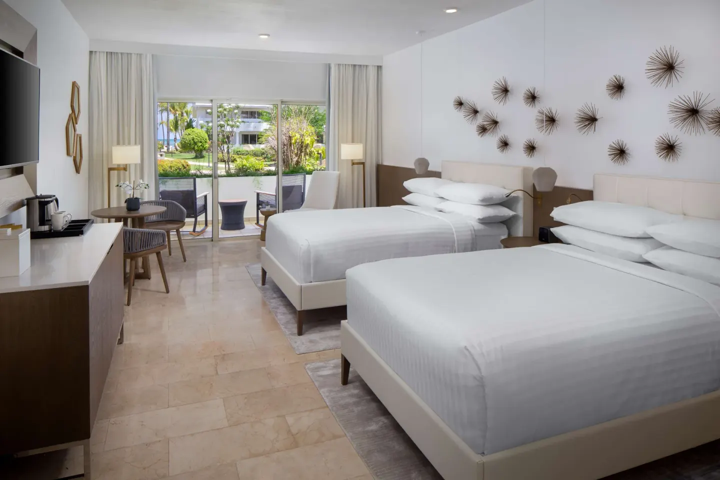 Accessible room with two beds, patio doors and sitting area at Hyatt Regency Grand Reserve Puerto Rico.