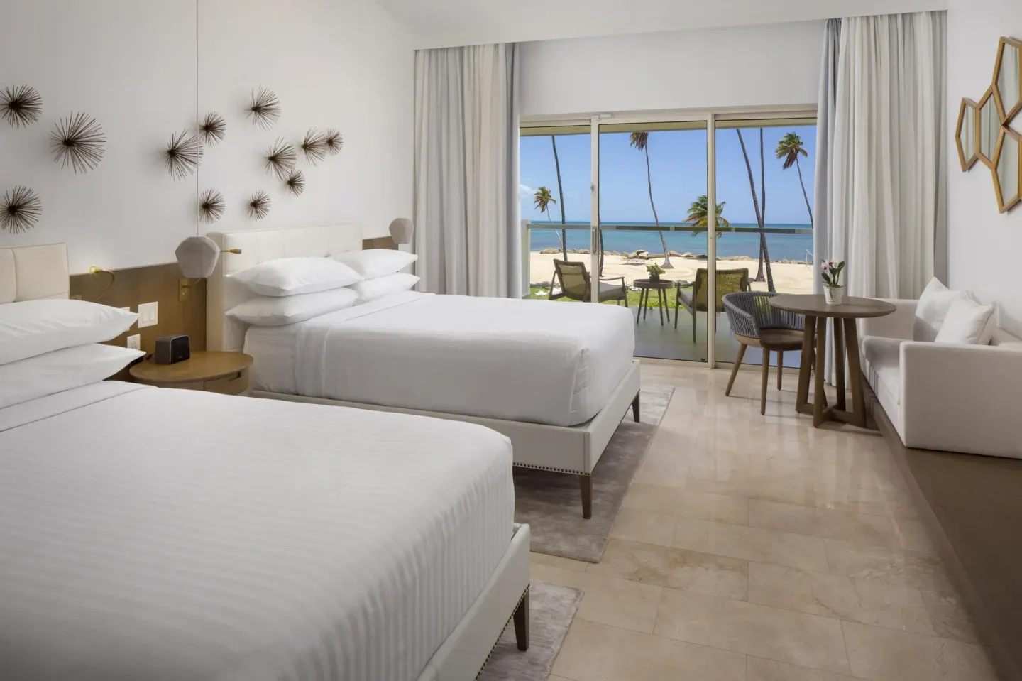 Ocean View room with two beds and beachfront balcony at Hyatt Regency Grand Reserve Puerto Rico.