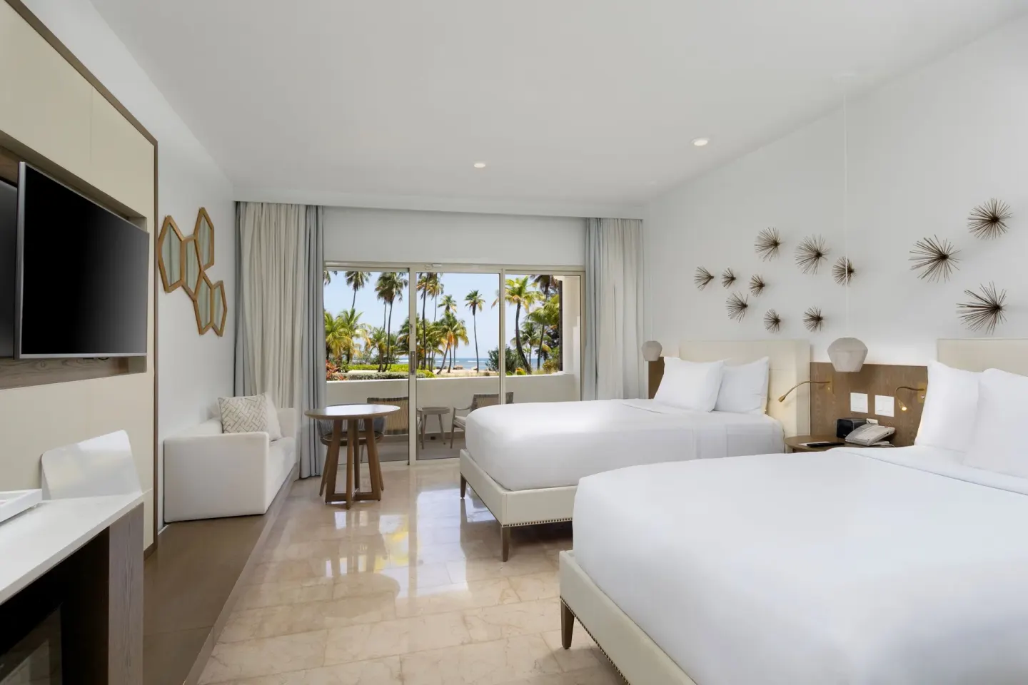 Ocean View room with two beds and palm-framed view at Hyatt Regency Grand Reserve Puerto Rico.