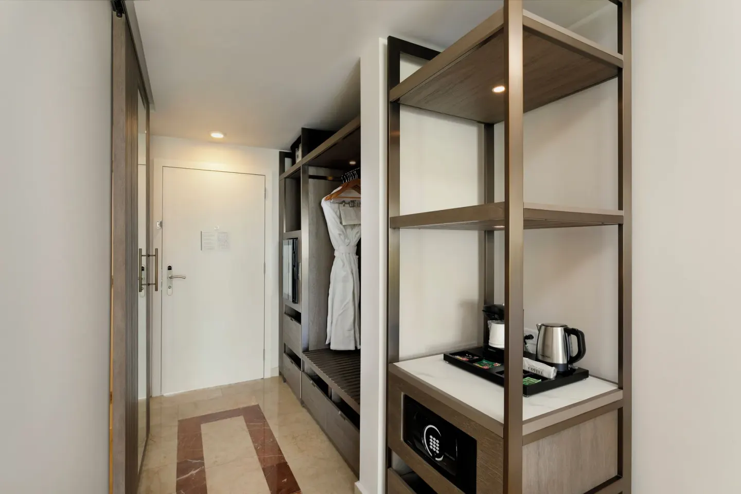 Guest room entry with closet, robe, safe, and coffee station at Hyatt Regency Grand Reserve Puerto Rico.