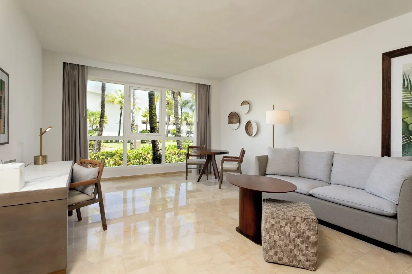 Guest room sitting area with sofa and garden windows at Hyatt Regency Grand Reserve Puerto Rico.