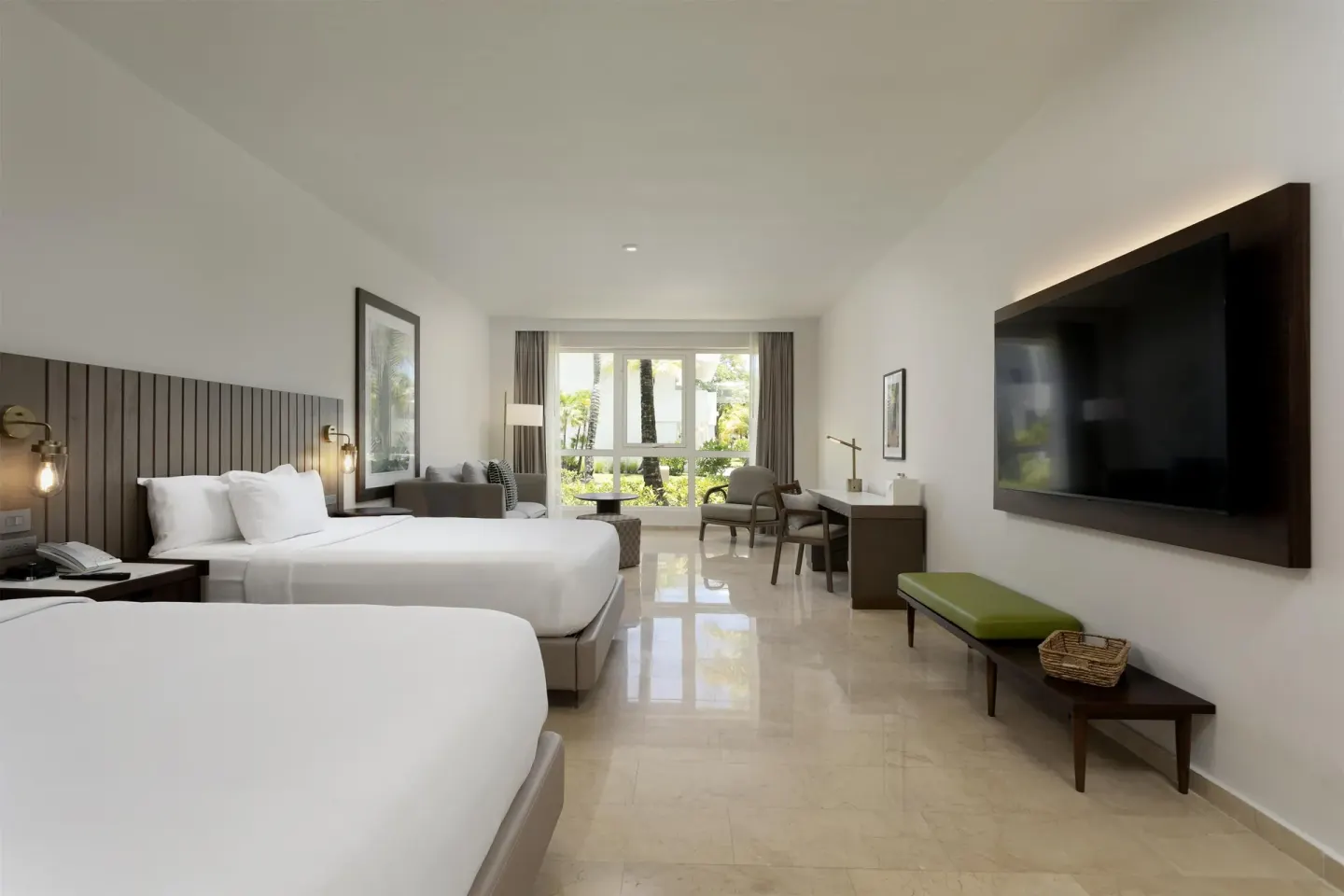 Two-bed guest room with TV and sitting area at Hyatt Regency Grand Reserve Puerto Rico.