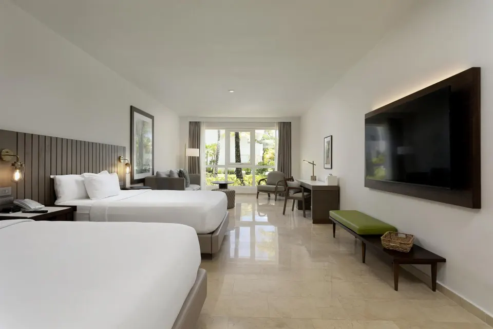 Two-bed guest room with TV and sitting area at Hyatt Regency Grand Reserve Puerto Rico.